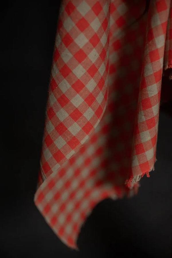 Red and white checkered fabric on a dark background