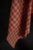 Red and white checkered fabric on a dark background