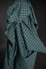 Green checkered fabric draped over a dark background