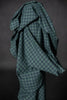 Green checkered fabric draped over a dark background
