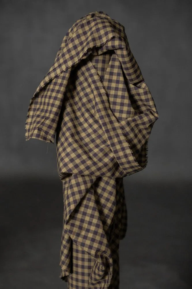 Plaid fabric draped over a dark background