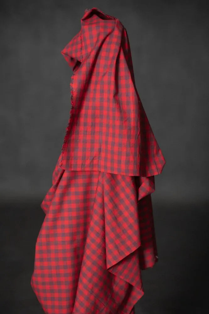 Red checkered fabric draped over a black background