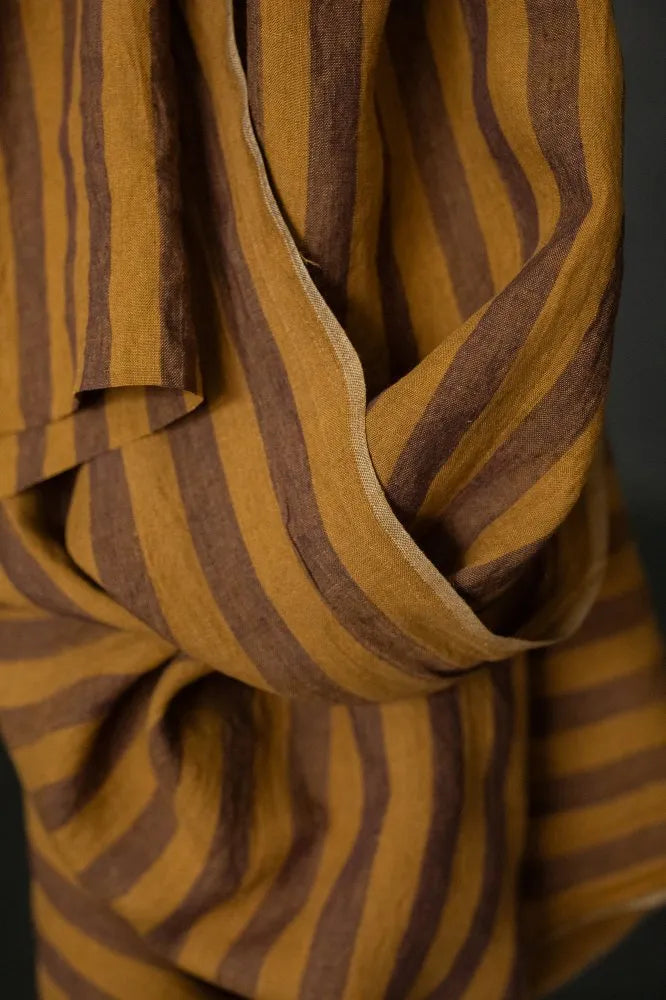 Close-up of a striped fabric with brown and yellow colors.