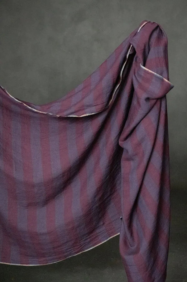 Striped fabric draped over a surface with a neutral background