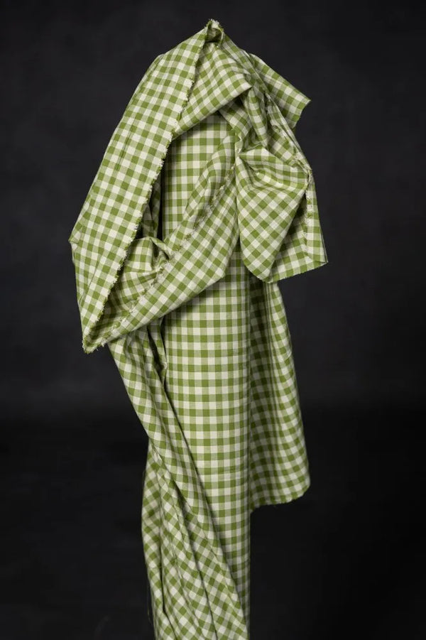 Green checkered fabric draped over a black background