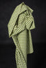 Green checkered fabric draped over a black background