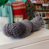 grey skein of wool on white wooden shelf