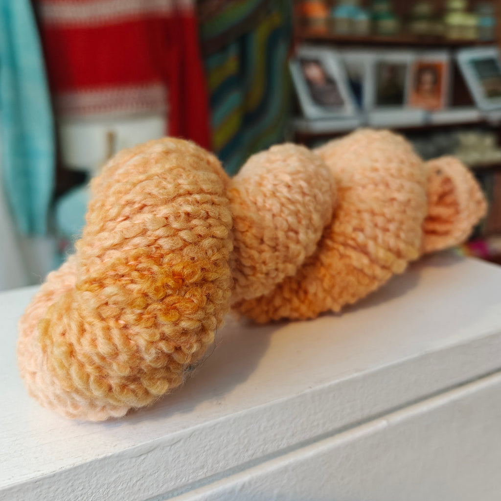 skein of ight orange merino boucle wool