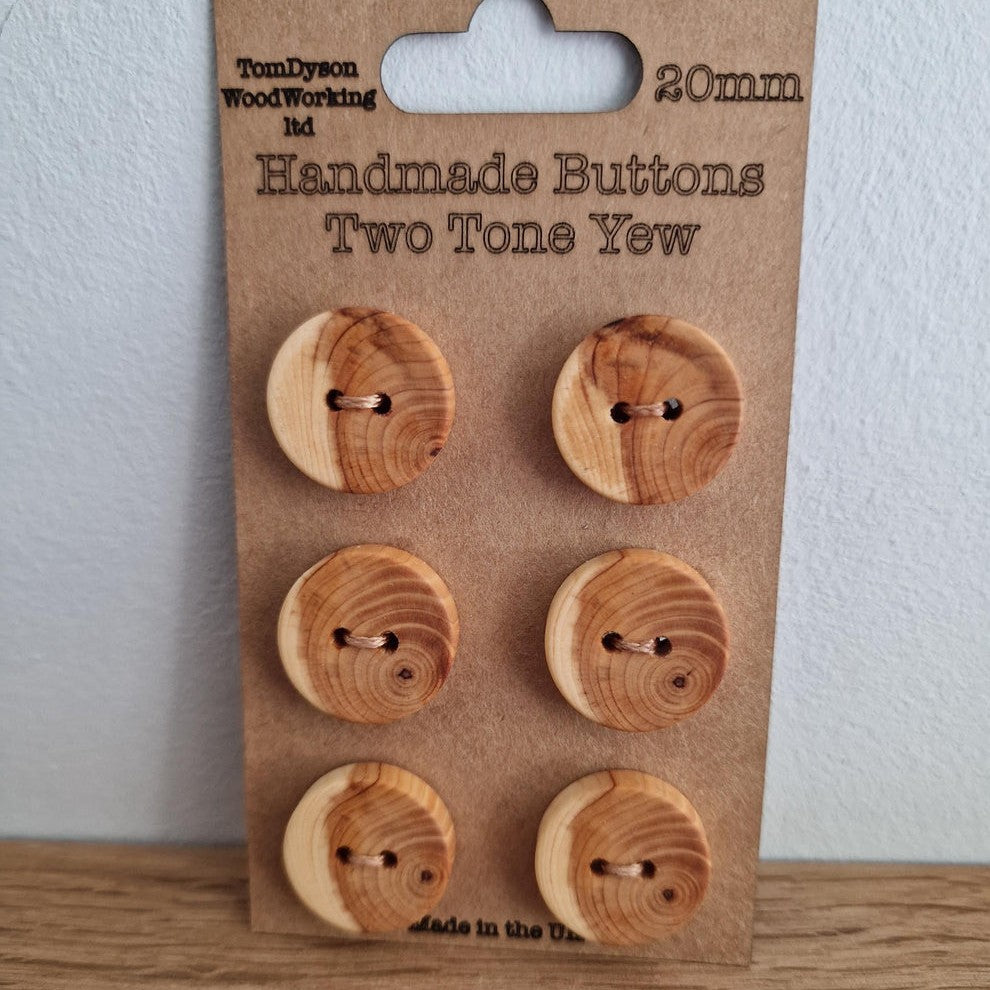 6 wooden buttons on a piece of brown card