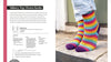 A knitting pattern booklet page showing the 'Sidney Top-Down Socks' project, with text instructions on the left and a photo of a person's feet wearing rainbow-striped socks on the right.