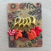 Set of colorful keychain charms on a floral card