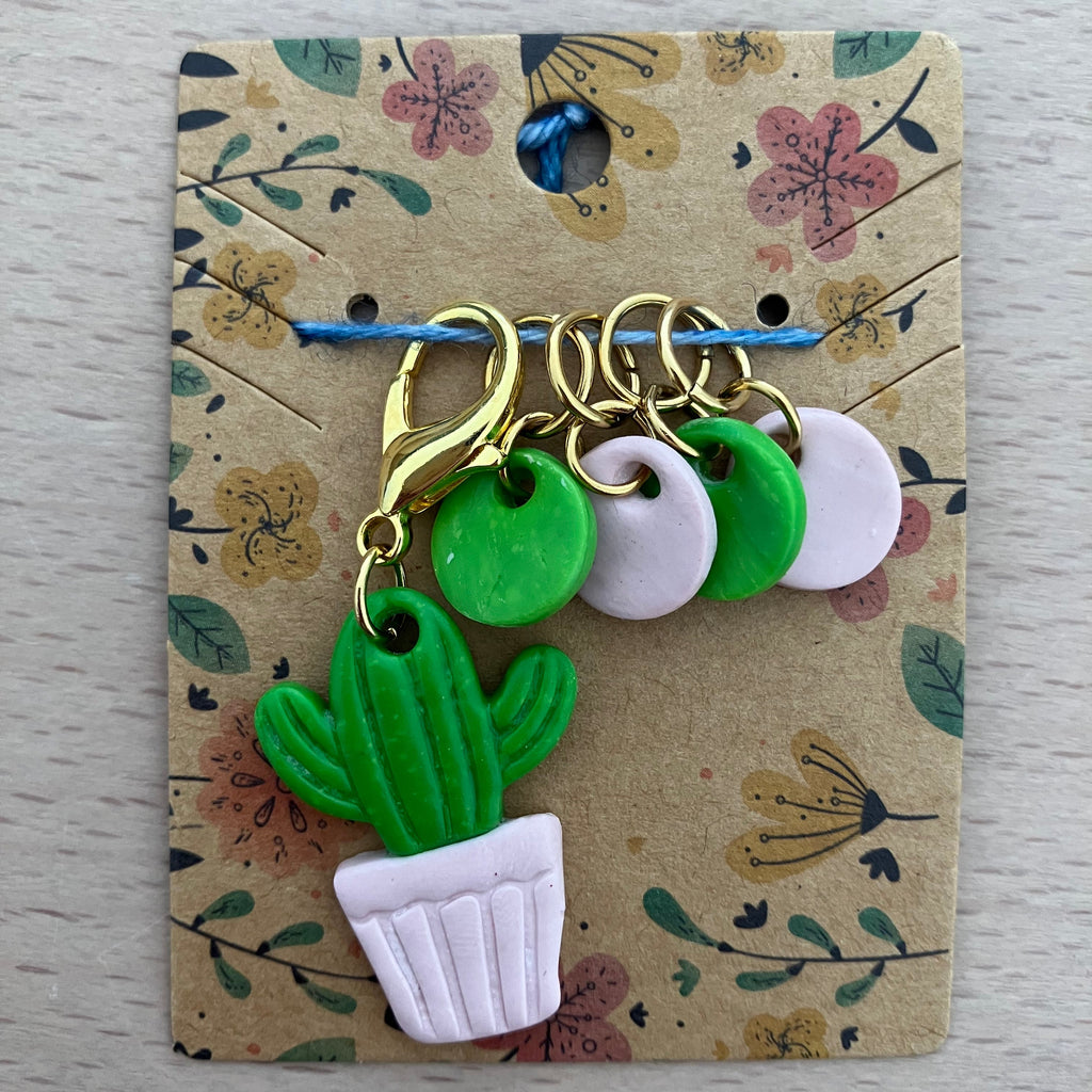 Cactus-shaped earrings on a floral card