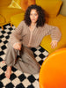 Woman sitting on a checkered floor in a room with yellow furniture