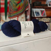 a skein of navy blue wool on a shop shelf