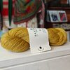 skein of yellow wool on a shelf in a yarn shop