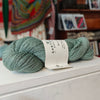 skein of blue green wool on a shelf in a shop