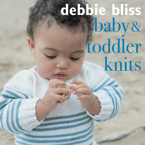 A baby wearing a striped knit sweater, with the book title 'debbie bliss baby & toddler knits' displayed above.