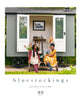 The image features the cover of the book "Bluestockings" by Kate Davies and Nicole Pohl. The cover shows two women seated outside a cozy, rustic-looking structure that resembles a shepherd's hut.